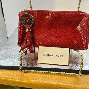 Michael Kors cosmetic bag or you could use it as a small purse. Beautiful red.‌